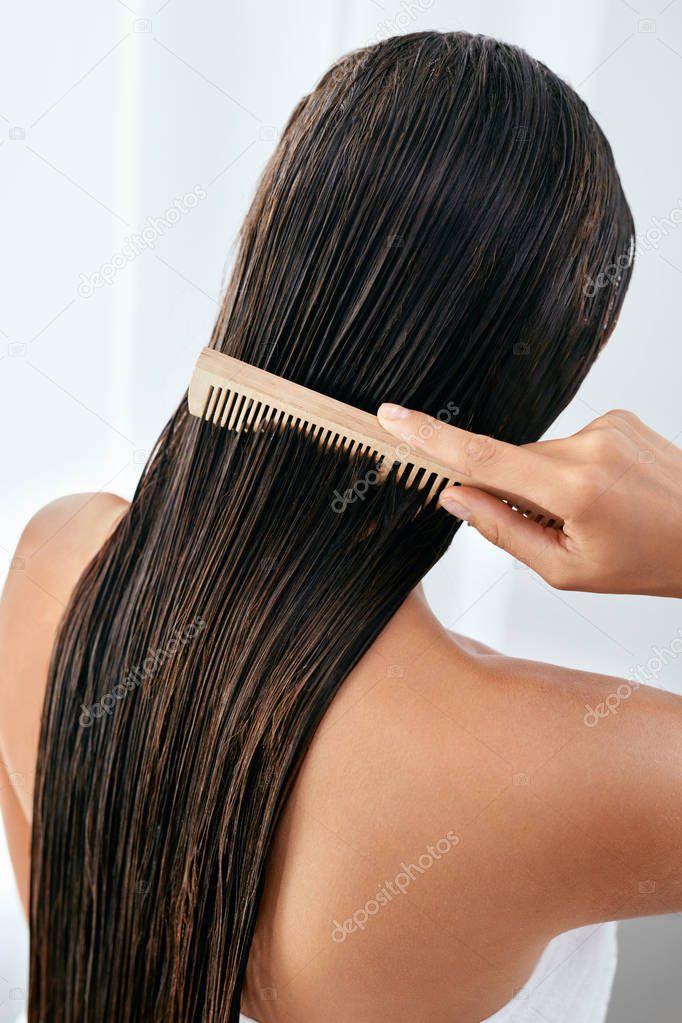 Hair Care. Beautiful Woman Brushing Wet Long Hair After Bath 