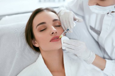 Lip Augmentation. Woman Getting Beauty Injection For Lips clipart