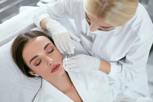 Beauty Injections. Woman Getting Face Lifting Procedure Closeup