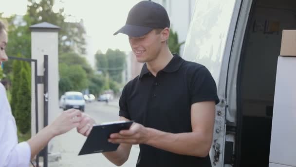 Kurierdienst. Mann übergibt Paket an Frau — Stockvideo