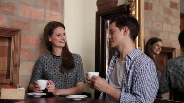 Couple In Cafe. Young People Drinking Coffee And Communicating — Stock Video