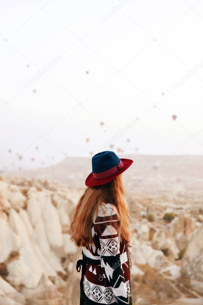 Travel. Beautiful Woman In Hat Watching Flying Hot Air Balloons 