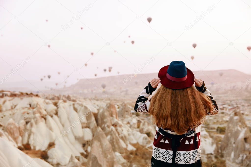 Travel. Beautiful Woman In Hat Watching Flying Hot Air Balloons 