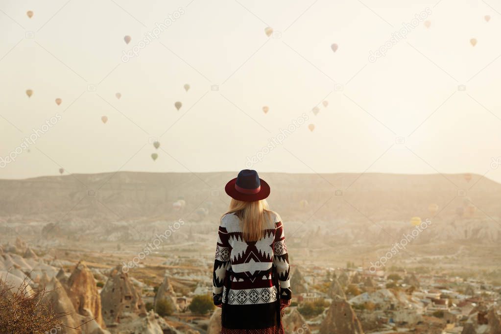 Travel. Beautiful Woman In Hat Watching Flying Hot Air Balloons 