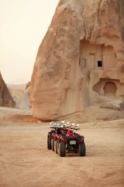 Travel. Red Quad Bikes Standing On Sand At Desert, ATV Vehicles