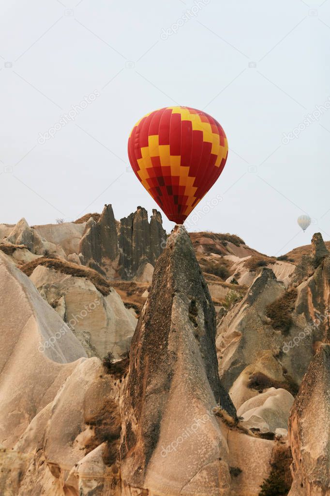 Colorful Hot Air Balloon Flying Between Rock Formations