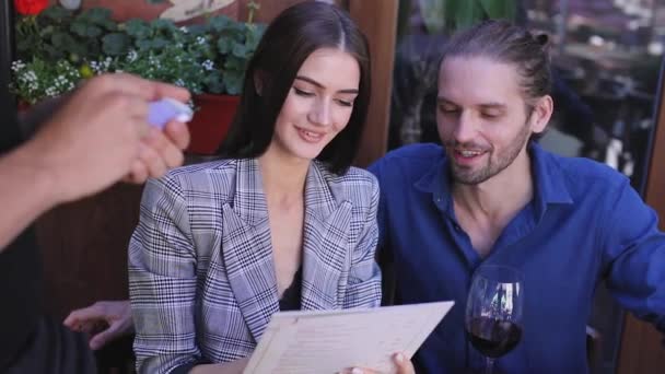 Par på restaurang. Personer med menyn göra beställning på Cafe — Stockvideo