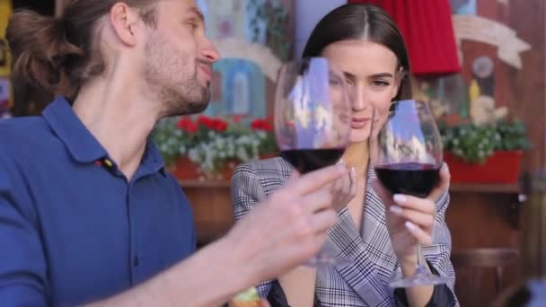 Pareja bebiendo vino tinto y comiendo comida en el restaurante de cerca — Vídeos de Stock