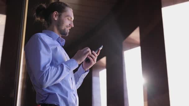 Üzleti ember használ mozgatható telefon közelében irodaház — Stock videók