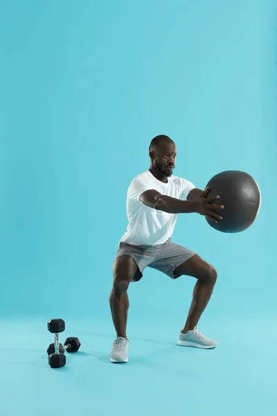 Training. Sportler turnen, Kniebeugen mit Medizinball — Stockfoto