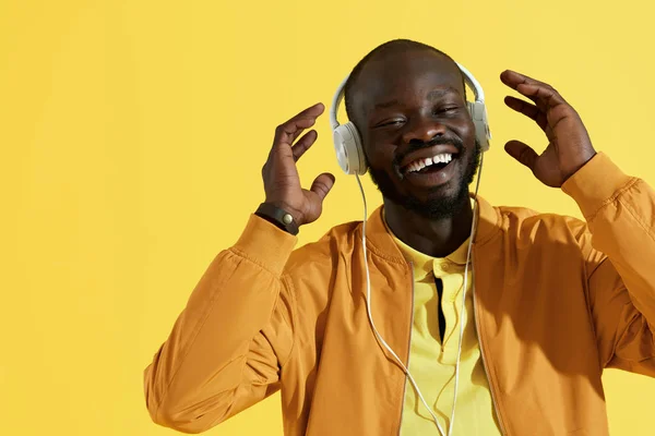 Happy black man in white headphone listening music portrait — Stok Foto