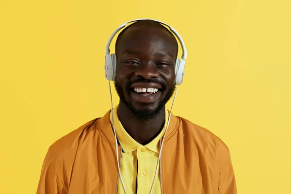 Happy black man in white headphone listening music portrait — Stok Foto