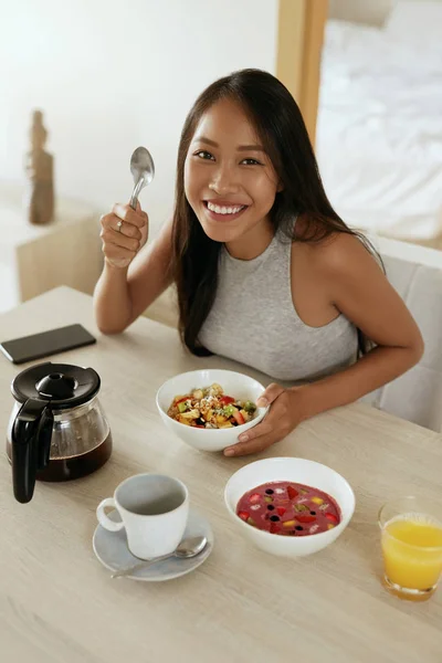 ผู้หญิงกินอาหารเช้าเพื่อสุขภาพที่บ้านตอนเช้าที่โต๊ะ — ภาพถ่ายสต็อก