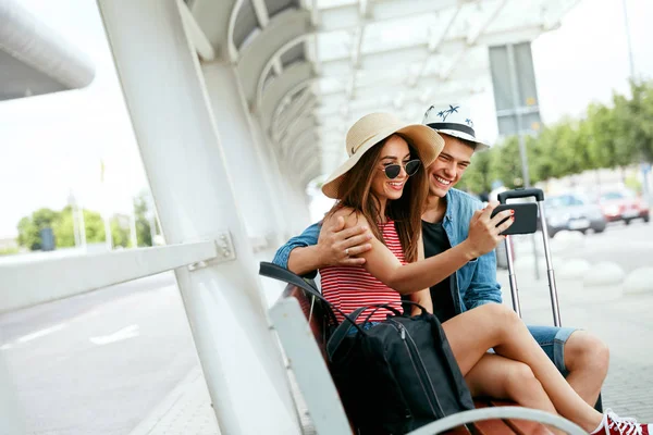 Travel. Couple Taking Photos On Phone Near Airport