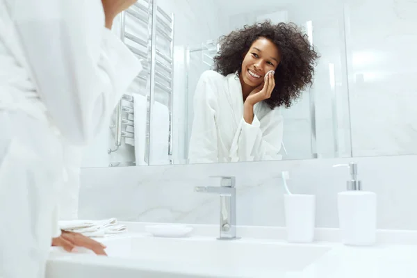 Cuidado de la piel. Chica quitando maquillaje con almohadilla de algodón en el baño —  Fotos de Stock