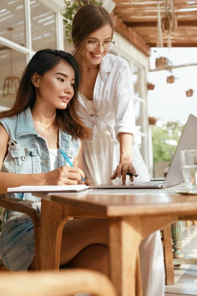 Online Job. Girls With Laptop At Cafe. Business Women In Casual Outfit Working At Coffee Shop. Digital Nomad Lifestyle For Remote Working Or Studying On Summer Vacation.