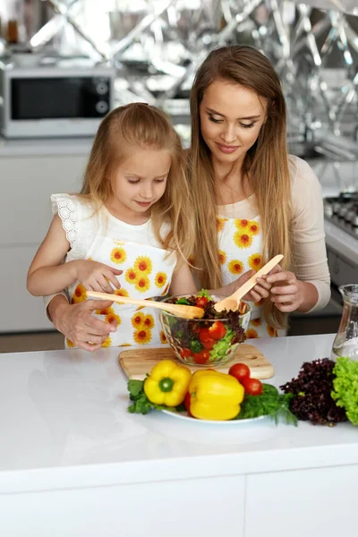부엌에서 건강에 좋은 식품을 요리하는 어머니와 함께. — 스톡 사진