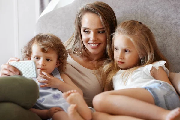 Mother And Children Using Phone At Home. — Stock Photo, Image