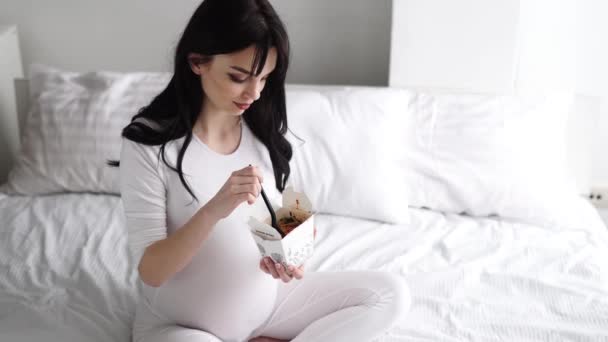 Pregnant Woman Eating Chinese Food At Home In Bed — Stock Video
