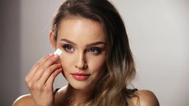 Güzellik makyajı. Süngerle Yüze Kozmetik Uygulayan Kadın
