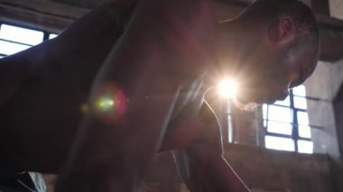 Spor adamı spor salonunda ağırlık çalışıyor.