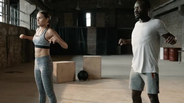 Fitness couple warming up, doing arms stretching exercise at gym — Stock Video