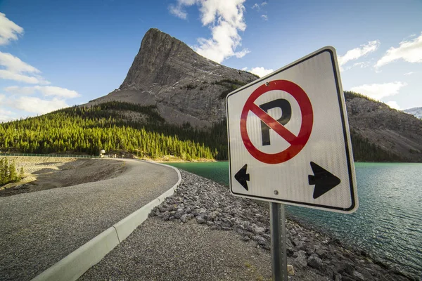 Asphalt road at mountains with street sign