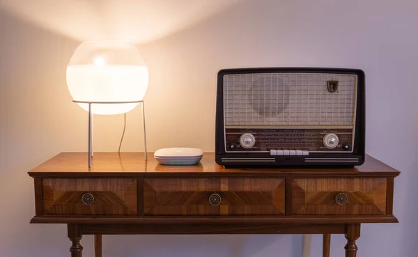 Modern versus old technology - new wi-fi access point next to an vintage radio