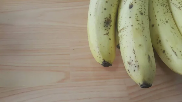 木製の床にプラスチック製のチェンジエアや容器に入れ栽培熟したバナナのビューを閉じます テキストの果実の背景 — ストック写真