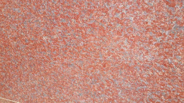 Closeup texture of red concrete floor. Background of a red concrete in sunshine