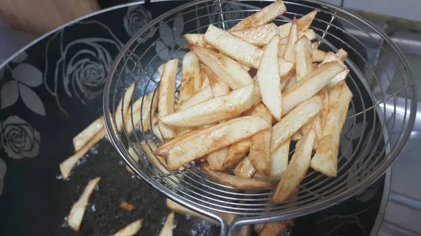 Крупный план картофельной картошки фри или жареных картофельных палочек в металлическом взгляде — стоковое фото