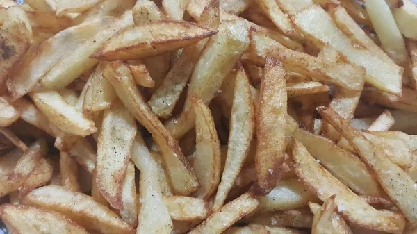 Vista de cerca de papas fritas o palitos de papas asadas —  Fotos de Stock