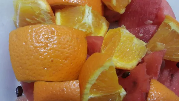 Vista de perto de frutas mistas fatias de laranjas cítricas e melancia vermelha doce — Fotografia de Stock