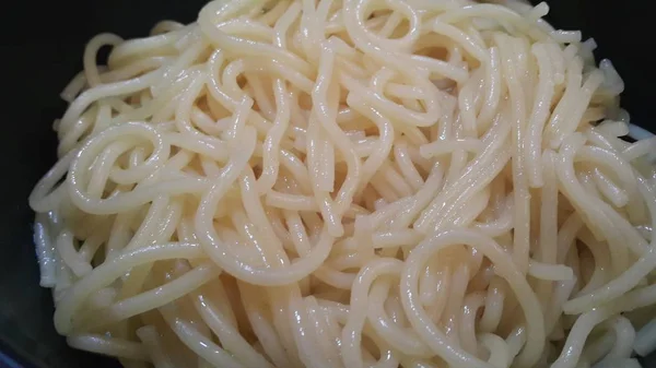 Close up view of swirling noodles or spaghetti pasta — Stock Photo, Image