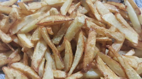 Vista de cerca de papas fritas o palitos de papas asadas —  Fotos de Stock