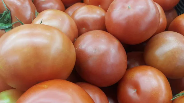 Red tomatoes in red basket in market for sale — Stock Photo, Image