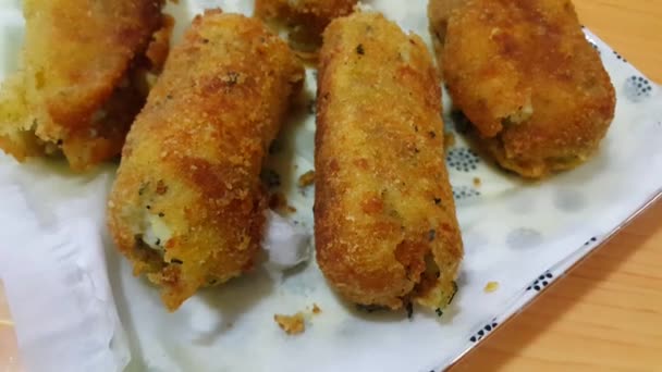 Closeup perspective view of home made spicy and delicious croquettes served with tea or other dishes during parties as fast food. — Stock Video