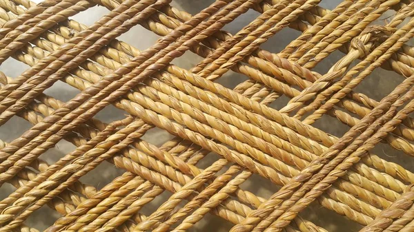 Crisscross dried jute ropes interwoven for making traditional bed called charpai — Stock Photo, Image
