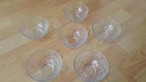 Top view of empty white glass bowls on a wooden floor — Stock Photo, Image