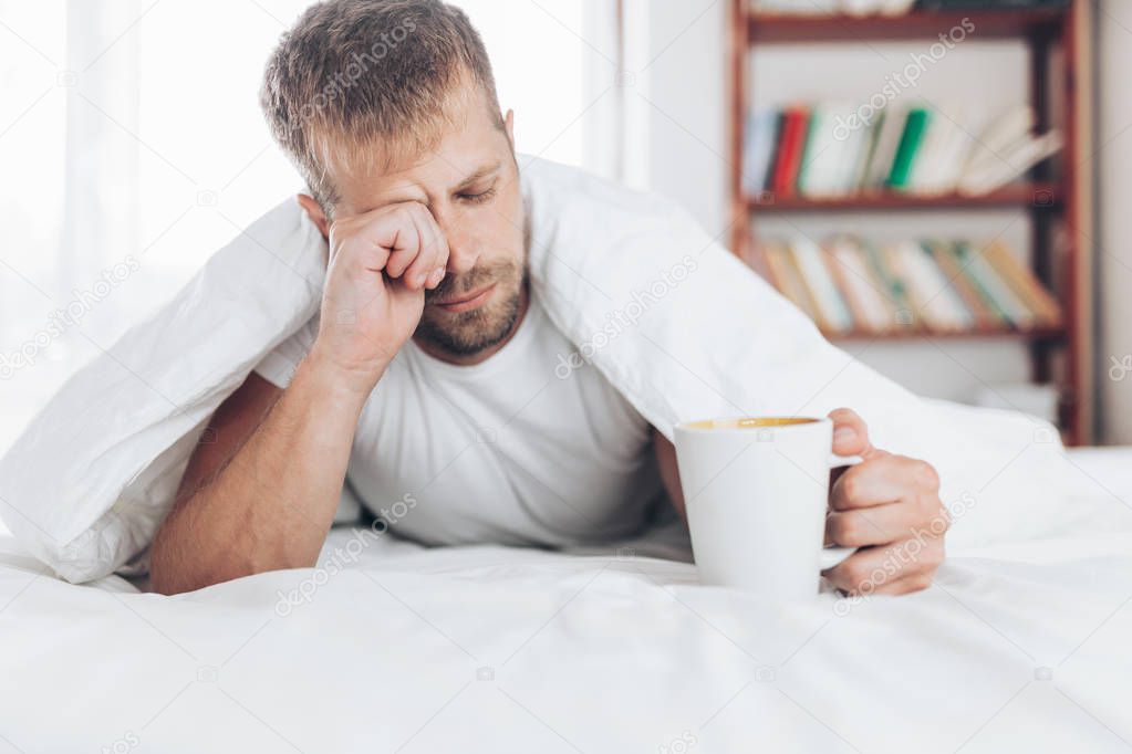 Man trying to wake up in the morning after night out