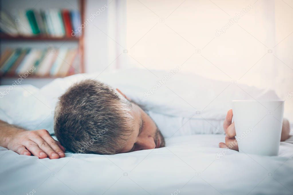 Man trying to wake up in the morning after night out