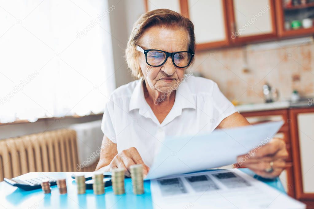 Senior woman at home checking her finances and investments