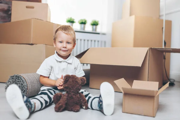 Cute toddler helping out packing boxes and moving