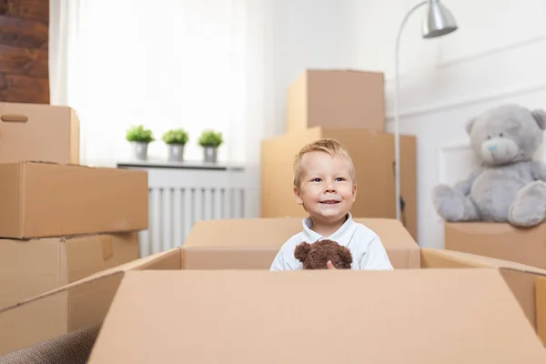 Cute toddler helping out packing boxes and moving