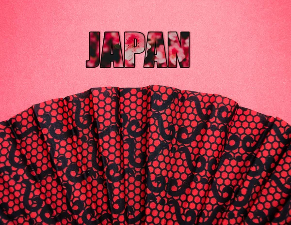 日本の碑文とピンクの背景に赤い模様のファン — ストック写真