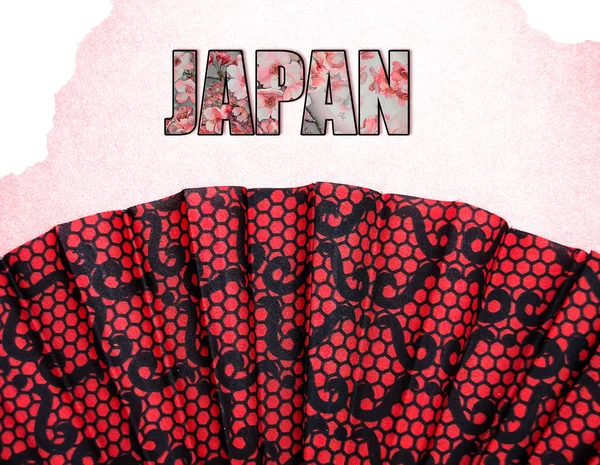 yazıt Japonya ile pembe bir arka plan üzerinde kırmızı desenli fan