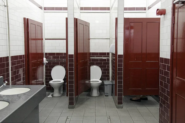 Kırmızı ve beyaz fayans ve sekoya vernikli kapılar ile Viktorya tarzı kamu banyo.