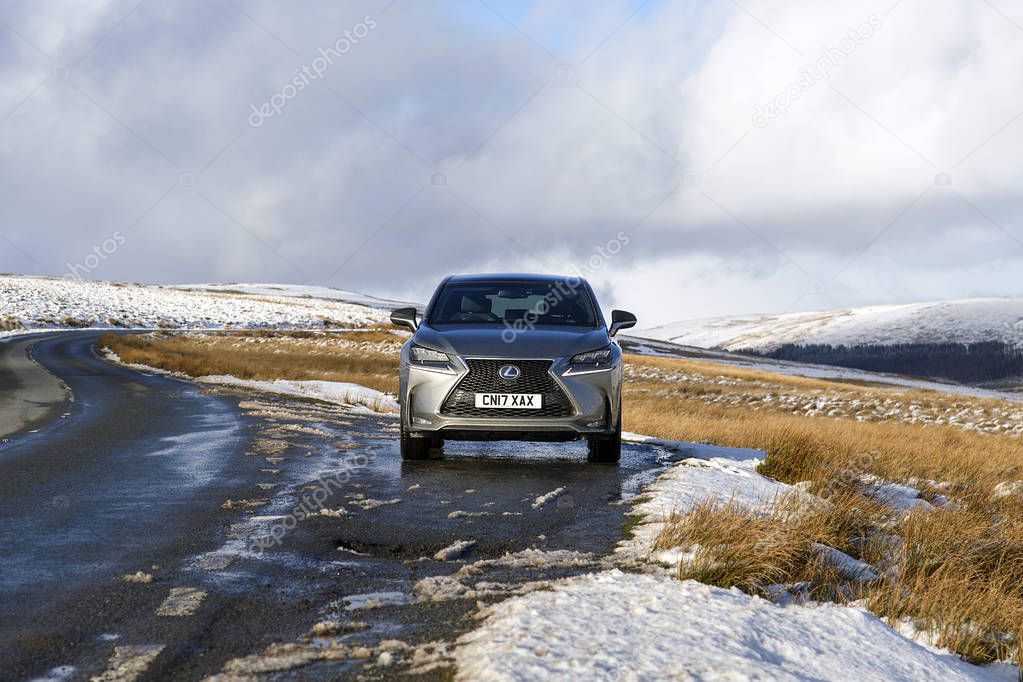Brecon Beacons, UK:  January 30, 2019: Lexus NX 300h F-sport crossover hybrid car on the road side in snow and icy conditions.