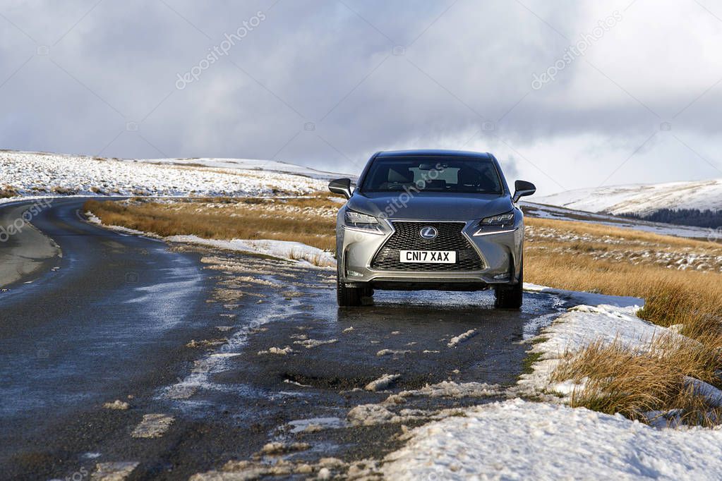 Brecon Beacons, UK:  January 30, 2019: Lexus NX 300h F-sport crossover hybrid car on the road side in snow and icy conditions.