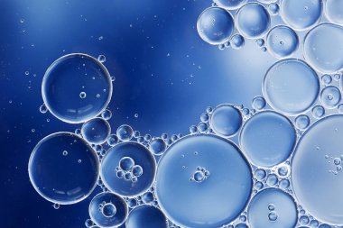Mavi ve beyaz degradeli ve yatay formatta hücre ve hücre zarının bilimsel bir görüntüsünü yaratan yağ ve su kabarcıklarının makrosu.